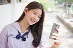 Portrait Of Thai Student Teen Beautiful Girl Using Her Smart Phone Selfie In School Stock Photo