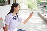 Portrait Of Thai Student Teen Beautiful Girl Using Her Smart Phone Selfie In School Stock Photo