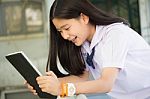 Portrait Of Thai Student Teen Beautiful Girl Using Her Tablet Stock Photo