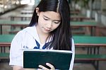 Portrait Of Thai Student Teen Beautiful Girl Using Her Tablet Stock Photo