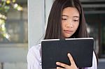 Portrait Of Thai Student Teen Beautiful Girl Using Her Tablet Stock Photo