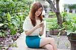 Portrait Of Thai Student University Beautiful Girl Using Her Smart Phone Stock Photo