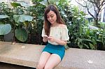 Portrait Of Thai Student University Beautiful Girl Using Her Smart Phone Stock Photo