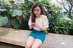 Portrait Of Thai Student University Beautiful Girl Using Her Smart Phone Stock Photo