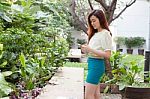 Portrait Of Thai Student University Beautiful Girl Using Her Smart Phone Stock Photo