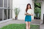 Portrait Of Thai Student University Beautiful Girl Using Her Smart Phone Stock Photo