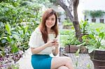 Portrait Of Thai Student University Beautiful Girl Using Her Smart Phone Stock Photo