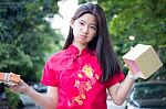 Portrait Of Thai Teen Beautiful Girl In Chinese Dress, Happy New Year And Open Box Gift, Smile And Very Happy Stock Photo