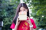 Portrait Of Thai Teen Beautiful Girl In Chinese Dress, Happy New Year And Open Box Gift, Smile And Very Happy Stock Photo