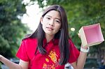 Portrait Of Thai Teen Beautiful Girl In Chinese Dress, Happy New Year And Open Box Gift, Smile And Very Happy Stock Photo