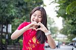 Portrait Of Thai Teen Beautiful Girl In Chinese Dress, Relax And Smile Stock Photo