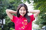 Portrait Of Thai Teen Beautiful Girl In Chinese Dress, Relax And Smile Stock Photo