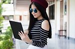 Portrait Of Thai Teen Beautiful Girl Using Her Tablet Stock Photo