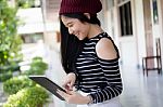 Portrait Of Thai Teen Beautiful Girl Using Her Tablet Stock Photo