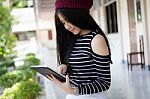 Portrait Of Thai Teen Beautiful Girl Using Her Tablet Stock Photo