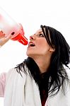 Portrait Of Woman Taking Refreshment On White Background Stock Photo