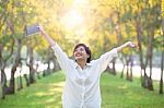 Portrait Of Young Asian Woman And Book In Hand Rising Hand As Vi Stock Photo