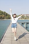 Portrait Of Young Beautiful Woman Jumping With Happy Emotion On Stock Photo