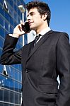 Portrait Of Young Businessman Talking With Smartphone Stock Photo