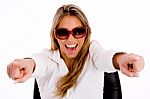 Portrait Of Young Female With Sunglasses Pointing With Both Hands Stock Photo