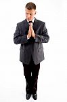 Praying Executive Looking Sideways Stock Photo