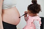 Pregnant Woman And Her Daughter Stock Photo