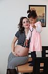 Pregnant Woman And Her Daughter Stock Photo