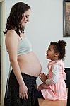 Pregnant Woman And Her Daughter Stock Photo