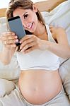 Pregnant Woman Taking A Self-portrait With Her Smartphone Stock Photo