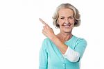 Pretty Aged Woman Pointing At Something Stock Photo