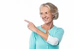 Pretty Aged Woman Pointing At Something Stock Photo