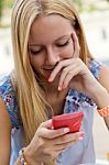 Pretty Blonde Young Woman Chatting With The Smartphone Stock Photo