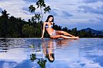 Pretty Brunette Model In Bikini Posing At The Pool Stock Photo