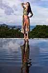 Pretty Brunette Model In Bikini Posing At The Pool Stock Photo