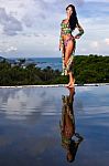 Pretty Brunette Model In Bikini Posing At The Pool Stock Photo