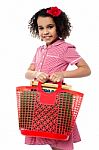 Pretty Child Carrying Math Equipment's In Basket Stock Photo