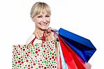 Pretty Female Carrying Shopping Bags Over Shoulders Stock Photo