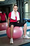 Pretty Fit Woman Sitting On Pink Swiss Ball Stock Photo