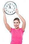 Pretty Girl Holding The Wall Clock Stock Photo