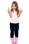 Pretty Girl In Trendy Wear Showing Double Thumbs Up Stock Photo