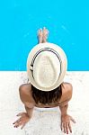 Pretty Girl Relaxing At The Swimming Pool In The Summertime Stock Photo