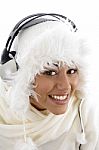 Pretty Girl Wearing Winter Clothes And Listening To Music Stock Photo