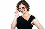 Pretty Lady Adjusting Her Eyeglasses Stock Photo