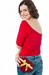 Pretty Model Posing With Gift In Her Back Pocket Stock Photo