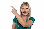 Pretty Teen Pointing Away On White Background Stock Photo