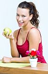 Pretty Woman Eating One Green Apple Stock Photo