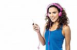 Pretty Woman Enjoying Music Stock Photo