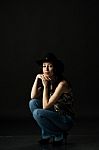 Pretty Woman In Black Hat In Studio Stock Photo