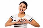 Pretty Woman Making Heart Symbol With Hands Stock Photo