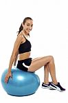 Pretty Woman Relaxing On Big Blue Exercise Ball Stock Photo